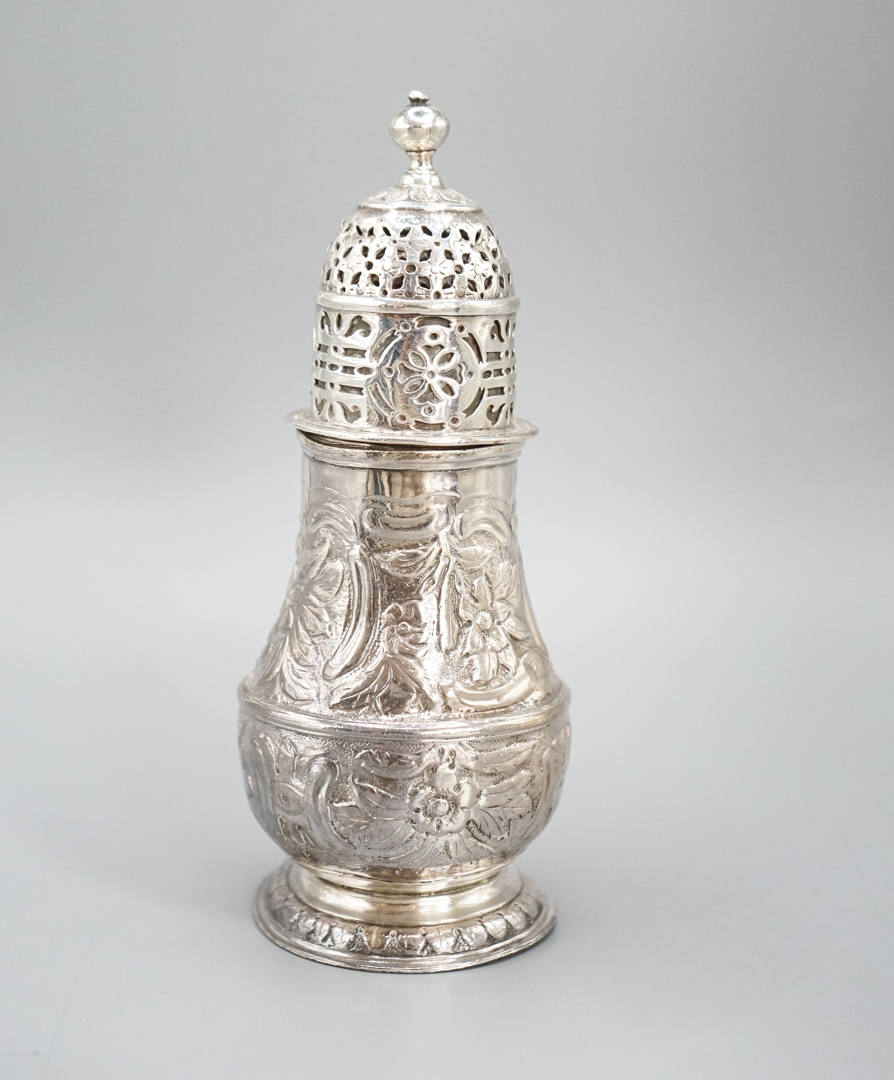 A George I silver sugar caster, with later? embossed decoration, Charles Adam, London, 1716, 13.5cm, 4.5oz.